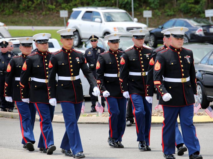 Marines of Battery M, 3rd Battalion 14th Marine Regiment, Marine Forces Reserve, march together at the Methodist Church in Hixson, Tennessee, July 24, 2015. The Marines attended the funeral of their fallen brother, Staff Sgt. David A. Wyatt, one of five service members killed by a gunman at the Naval Operational Support Center and Marine Corps Reserve Center on July 16, 2015. Wyatt was taken to the Chattanooga National Cemetery after the church service to be laid to rest with full military honors. (U.S. Marine Corps photo by Cpl. Sara Graham)