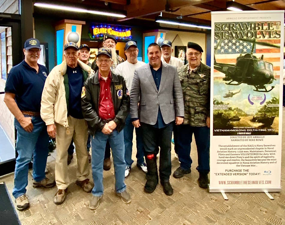 Jeff Arballo (gray coat), producer of the must see documentary, Scramble The Seawolves, proudly stands with Vietnam War veteran Seawolves, who are in the film that was shown at the Branson IMAX Military Film Festival on November 6, 2019. (Image created by USA Patriotism! from photo provided by Jeff Arballo)