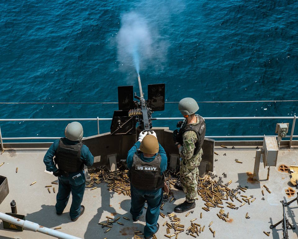 July 10, 2021 – Sailors conduct live-fire training aboard expeditionary sea base USS Lewis B. Puller (ESB 3) in the Arabian Gulf. (Image created by USA Patriotism! from U.S. Navy photo by Mass Communication Specialist 3rd Class Dawson Roth.)