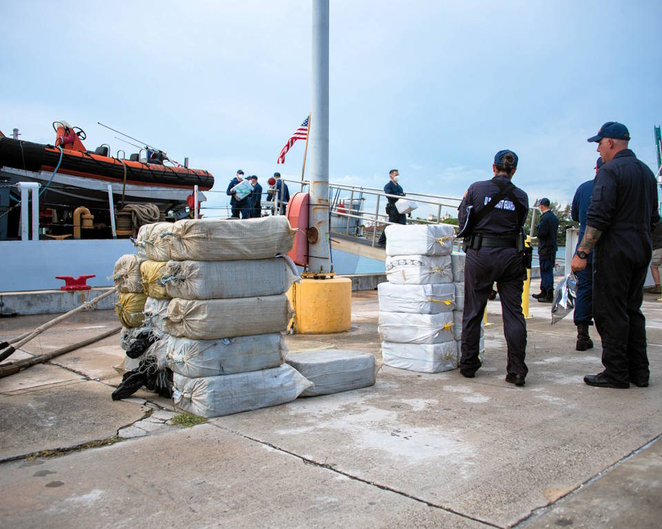 June 17, 2022 - U.S. Coast Guard Cutter Thetis' (WMEC 910) crew offloads more than $99 million in illegal narcotics at Coast Guard Base Miami Beach, Florida. (Image created by USA Patriotism! from U.S. Coast Guard photo by Petty Officer 3rd Class Vincent Moreno.)