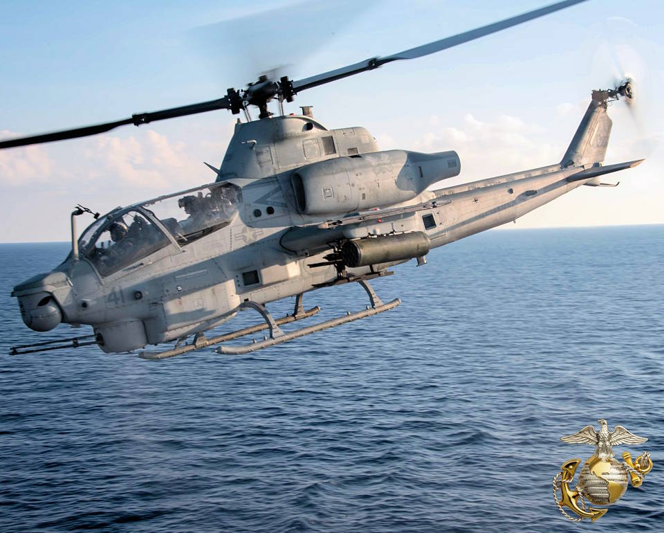 July 26, 2022 - A U.S. Marine Corps AH-1Z Cobra helicopter approaches the out of scene flight deck of the forward-deployed amphibious transport dock ship USS New Orleans (LPD 18) during flight operations at an undisclosed location in the East China Sea. (Image created by USA Patriotism! from U.S. Navy photo by Mass Communication Specialist 1st Class Desmond Parks.)