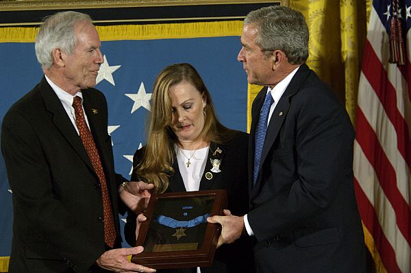 President George W. Bush presents the Medal of Honor to Daniel and Maureen Murphy, the parents of Navy SEAL Lt. Michael Murphy, during a ceremony at the White House. Lt. Murphy was killed during a reconnaissance mission near Asadabad, Afghanistan, while exposing himself to enemy fire in order to call in support after his four-man team came under attack by enemy forces June 28, 2005. Murphy is the first service member to receive the honor for actions during Operation Enduring Freedom and the first Navy recipient of the medal since Vietnam.