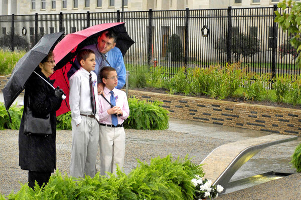 Regan Howell and his two sons, Ashton, 8, and Alex, 12, arrive early for the 9/11 remembrance ceremony at the Pentagon Memorial, Sept. 11, 2009. Howell's brother, who worked for the Navy at the Pentagon, was among the 125 Pentagon employees killed in the attack.