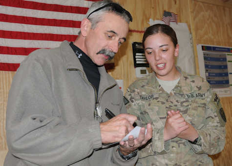 Pfc. Natascha Taylor, of Colorado Springs, Colo., currently deployed to Afghanistan with the 504th Battlefield Surveillance Brigade, gets an autograph from country music artist Aaron Tippin Nov. 27, 2011 at Forward Operating Base Spin Boldak, Afghanistan. Deployed in support of Operation Enduring Freedom, Taylor and the soldiers of the 504th BfSB are often without entertainment during the holiday season. Photo by Army Sgt. Marc Loi