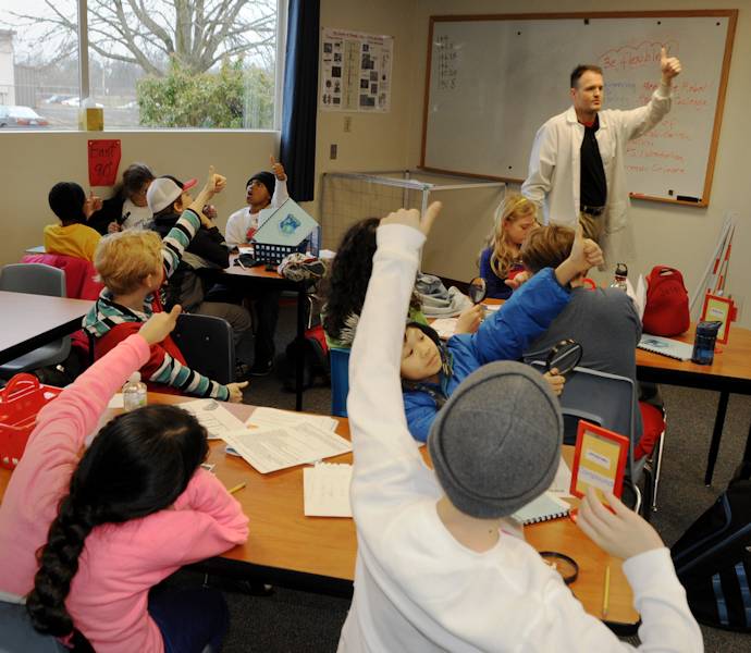 Jon Dyer, a State of Oregon Forensic Scientist, gives detailed instructions on a finger print experiment to a student group from Chief Joseph-Ockley Green Elementary School in Portland, Ore., Dec. 16, 2013. STARBASE Academies help teach more than 75,000 students nationally each year in math and science education. (Air National Guard photo by Tech. Sgt. John Hughel, 142nd Fighter Wing Public Affairs)