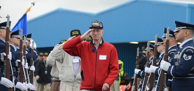 John Luckadoo, a D-Day veteran from the U.S. Army Air Corps, 100th Bomb Group, and his fellow veterans, march through two lines of riflemen as a ceremonial salute is rendered in their honor at Portsmouth, United Kingdom, June 3, 2014. The 422nd and 423rd Air Base Groups Honor Guard members of the 501st Combat Support Wing showed their respect and helped kick-off the veterans’ journey to Normandy to commemorate the 70th anniversary of the D-Day landings. (U.S. Air Force photo by Tech. Sgt. Chrissy Best)